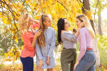 Summer autumn vacation, holidays, travel and people concept - group of young women in the park