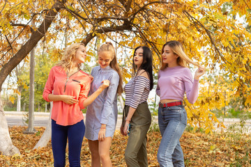 Summer autumn vacation, holidays, travel and people concept - group of young women in the park