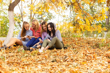 Summer autumn vacation, holidays, travel and people concept - group of young women in the park