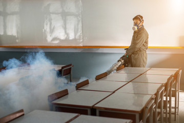 Man work fogging to eliminate mosquito for preventing spread dengue fever and zika virus