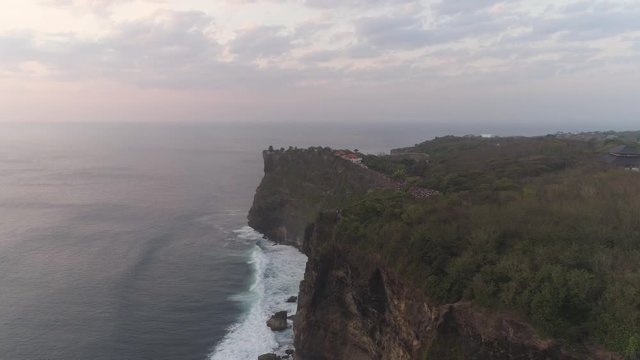 aerial view rocky ocean coastline at sunset. seascape waves break on rocky shore travel concept. aerial footage.