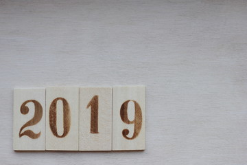 New year 2019 lined with wooden figures on the wooden surface
