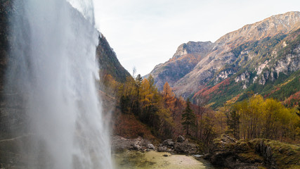 Waterfall in an autumn day in the italian alps