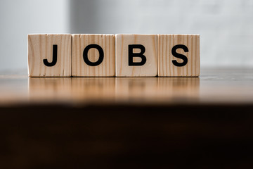 close-up shot of blocks with JOBS sign on wooden table