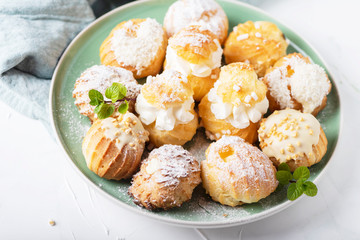 Delicious profiteroles with cream