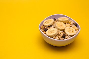 A bowl with banana, oats and cereal.