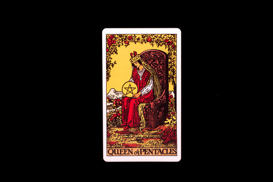 An individual minor arcana tarot card isolated on black background. Queen of pentacles.
