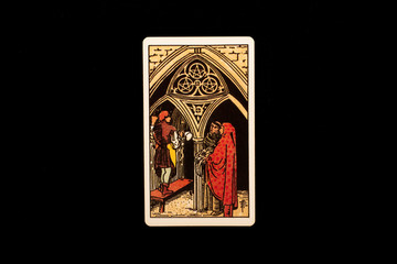 An individual minor arcana tarot card isolated on black background. Three of pentacles. - obrazy, fototapety, plakaty