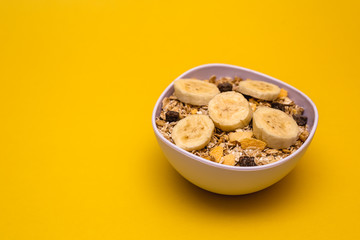 A bowl with banana, oats and cereal.