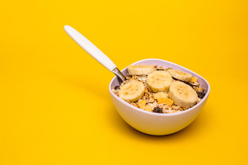 A bowl with banana, oats and cereal.