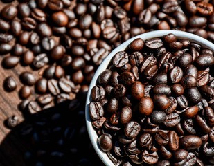 Coffee bean in cup on wood desk