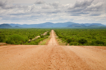 Gravel road with Zebra Mountains in Namibia