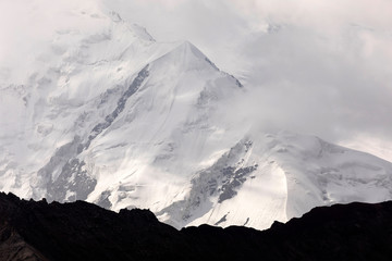 Pamir mountains with peak Lenin, which is shrouded by clouds, Kyrgyzstan