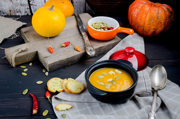 Fototapeta na wymiar Autumn Homemade Pumpkin soup in clay bowl