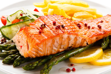 Grilled salmon, French fries and vegetables