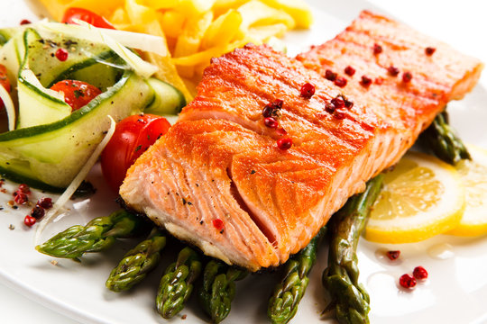 Grilled salmon, French fries and vegetables