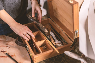 The artist works with a palette of paints