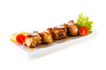Grilled chicken drumsticks on white background