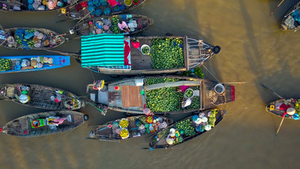 AERIAL, TOP DOWN: Flying away from people selling produce from wooden boats.
