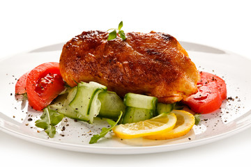Grilled chicken fillet with vegetables on white background