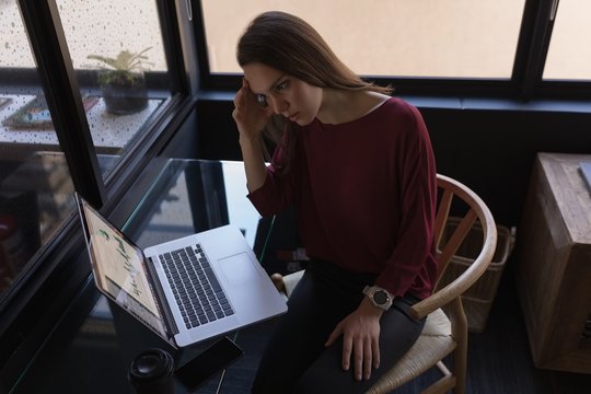 Businesswoman working on laptop in office