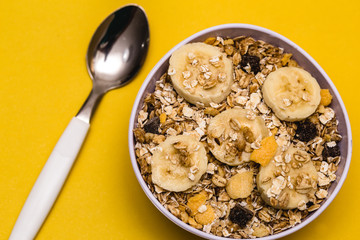 A bowl with banana, oats and cereal.