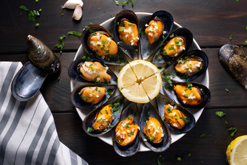 Cooked Mussels. Steamed mussels in white wine sauce with parsley and garlic. Tasty spanish seafood recipe. Top view