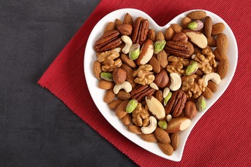 Nuts on a plate in the shape of a heart.