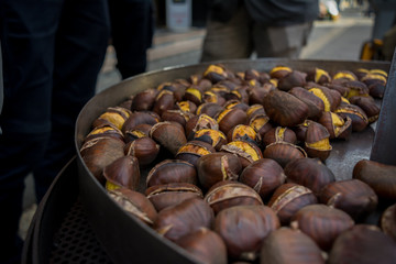 Selling of Chestnuts in an Italian Street called Caldarroste in Autumn on bLur Background.