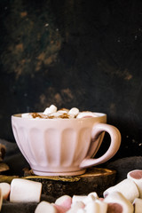Obraz na płótnie Canvas Good New Year spirit. Coffee with marshmallows and cinnamon. Pink mug. Cooking yourself. Photos for coffee. Home comfort. New Year. Christmas time. Winter mood.