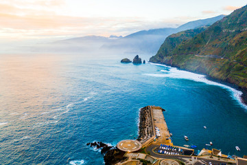 Aerial Madeira island view with Atlantic ocean, white waves, cliffs and green nature