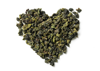 Heart shaped of oolong tea on white background. Top view. Close up. High resolution