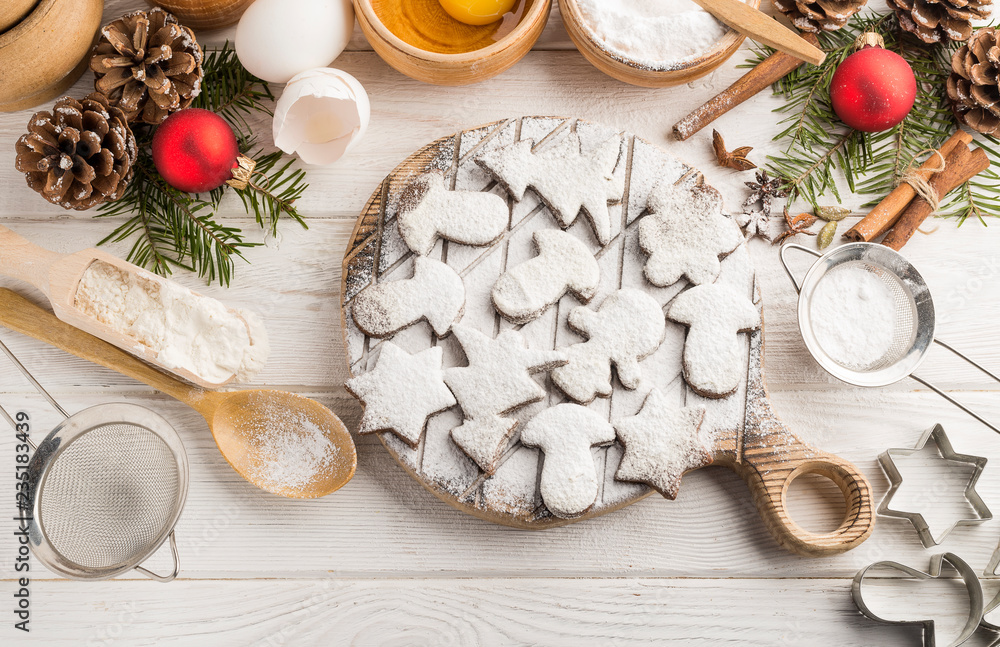 Wall mural homemade holiday baking with powdered sugar o a wooden white background. flat lay