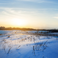 winter snowbound plain at the sunrise