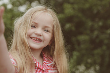 Happy and healthy. Happy little child with adorable smile. Little girl wear long hair. Small girl with blond hair. Small child happy smiling. Parting hair in the middle