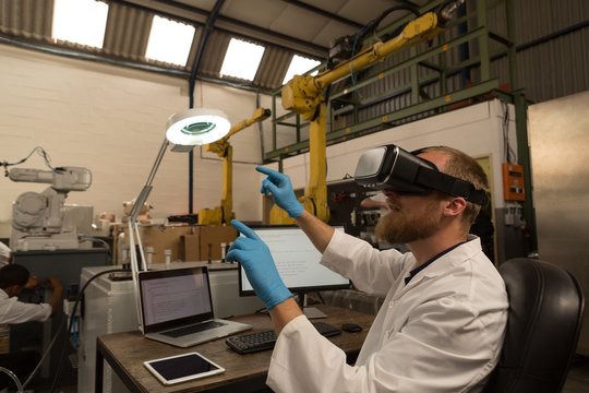 Engineer using virtual reality headset at desk