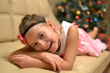 Obraz na płótnie Canvas Happy teen girl near decorated Christmas tree waiting for a miracle.