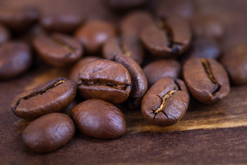 Roasted coffee beens on a wooden table, close up