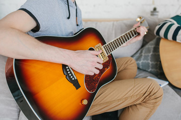 Learning to play the guitar. Interesting hobby or professional occupation of music. Music education or extracurricular activities or pastime