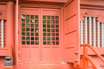 Brown vintage background with Japanese traditional temple architecture details featuring wooden doors, walls and windows with parallel and perpendicular elements in design. Tokyo, Japan.