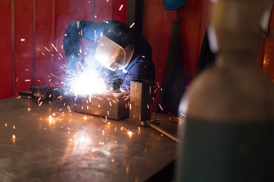 Robotic engineers using welding torch