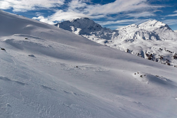 Fototapeta na wymiar Panoramic view of the snow-covered Alps in winter, in the canton of Graubünden in Switzerland.