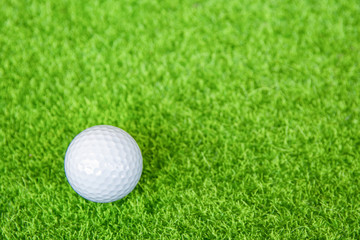 Golf ball on green grass ready to play at golf course. with copy space