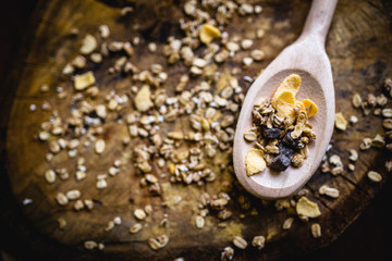 wooden spoon with oats, cereal and seeds.