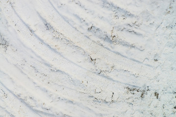 Drift on dirty snow close up. Maneuver on slippery snowy road. Track of tyres. View from above. Textured winter realistic background with copy space. Abstract minimalist snowy weather texture © Daniil
