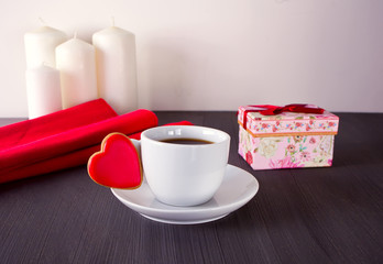 Cup of coffee and plaid on the wooden table
