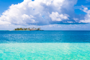 Beautiful landscape of tropical island and sail cruise yacht