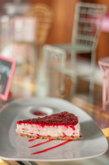 Delicious fresh raspberry cheesecake on white plate
