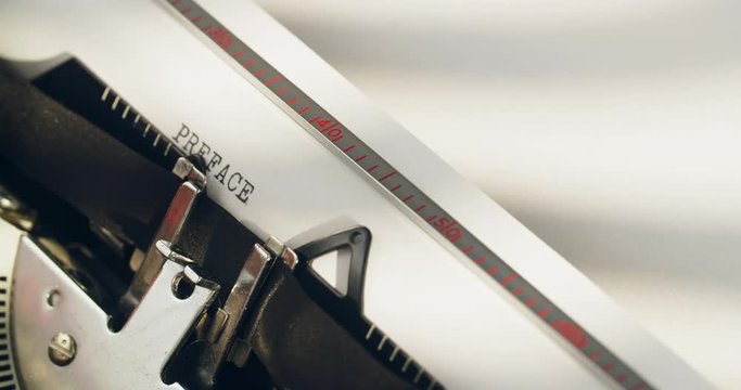 The word preface being typed on a typewriter.