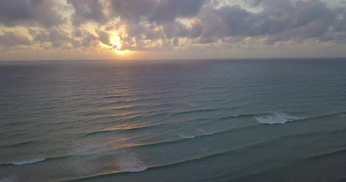 Aerial view beautiful tropical island beach sunrise, sunset from drone. Stock footage of landscape paradise tropical island beach with sunrise, sunset ocean water, wave, sea surface. Amazing nature